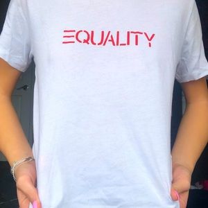 white t shirt. red writing: EQUALITY